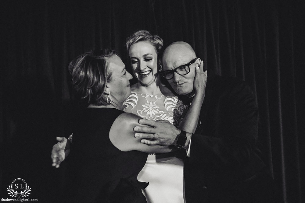 bride and parents hugging at Fabulous Fox Theater St Louis wedding