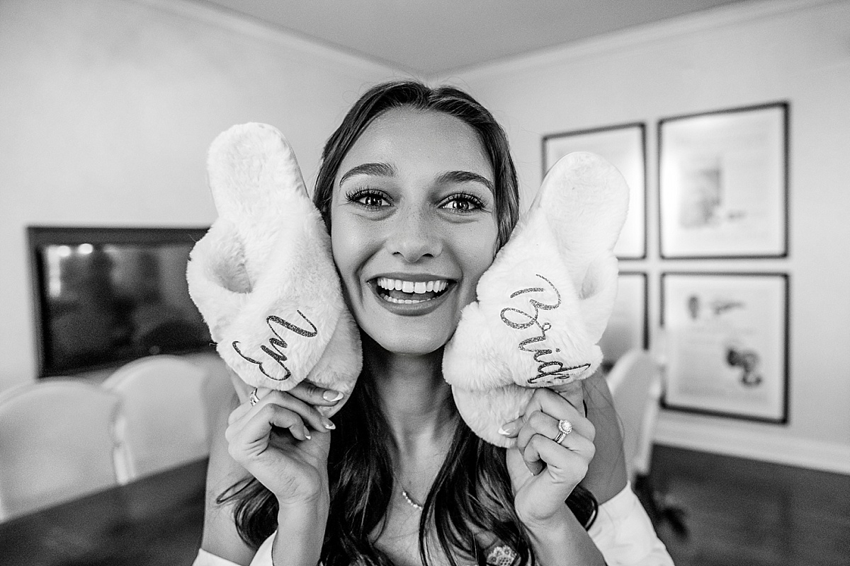 funny bride holding wedding slippers in St. Louis Union Station wedding photo