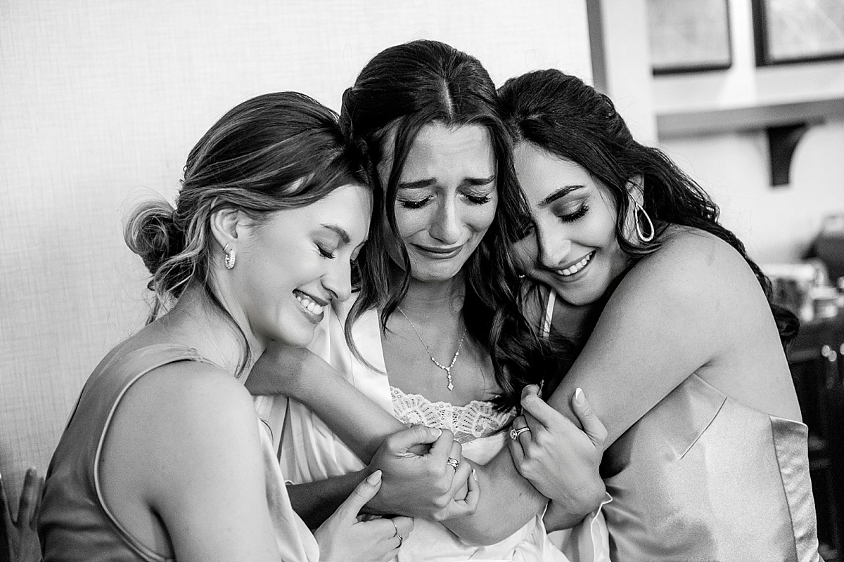 Bride and bridesmaids crying in sweet St. Louis Union Station wedding photo