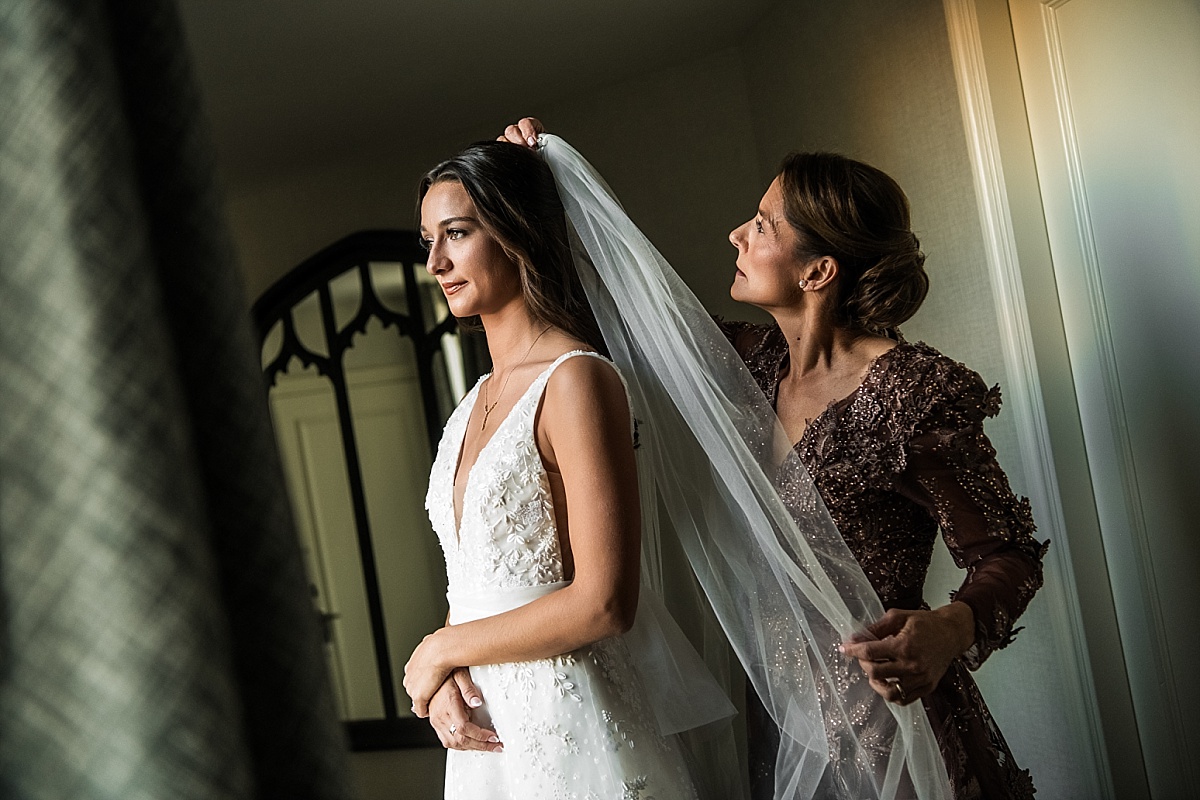 mother putting on the bride's veil in beautiful St. Louis Union Station wedding photo