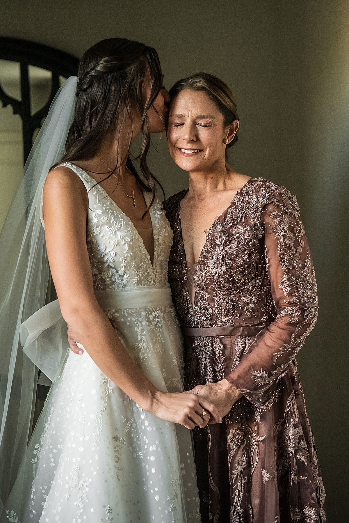 bride kissing her mother