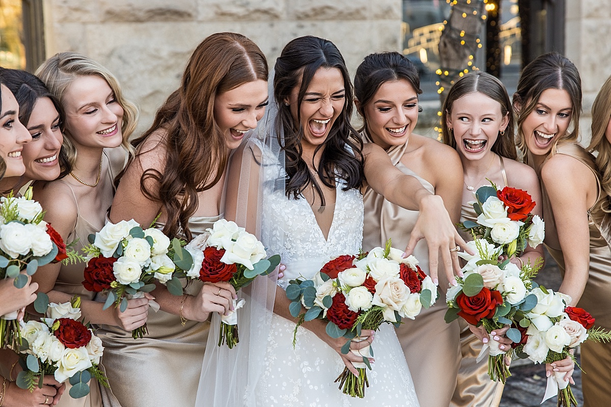 bride showing her ring and bridesmaids laughing in beautiful St. Louis Union Station wedding photo