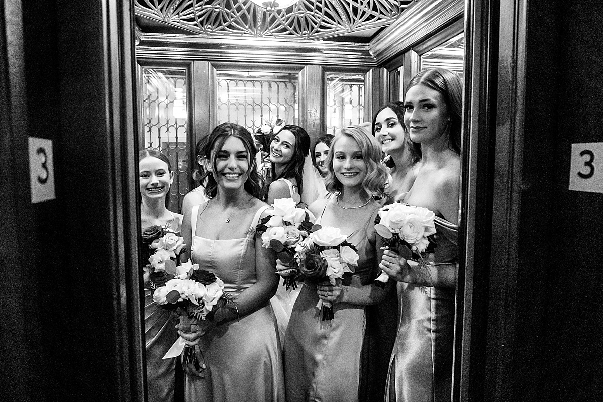 bride and bridesmaids in the elevator