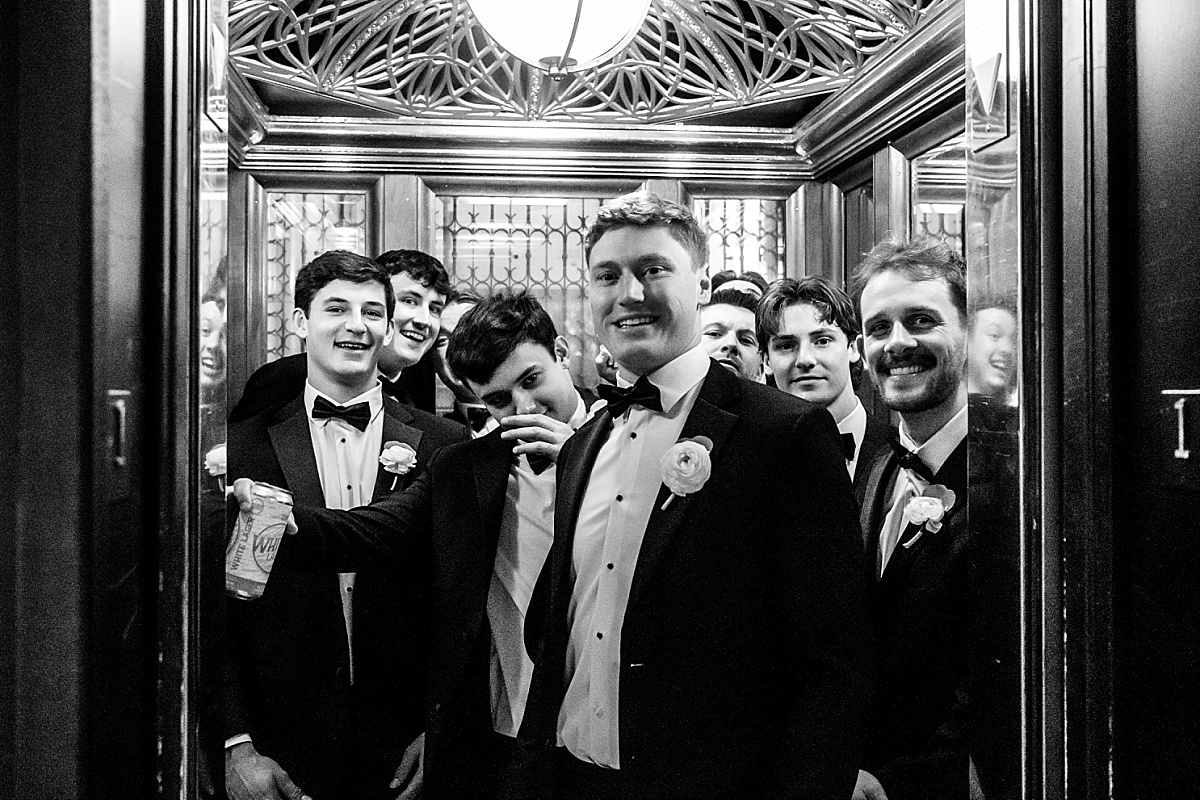 groom and groomsmen in the elevator