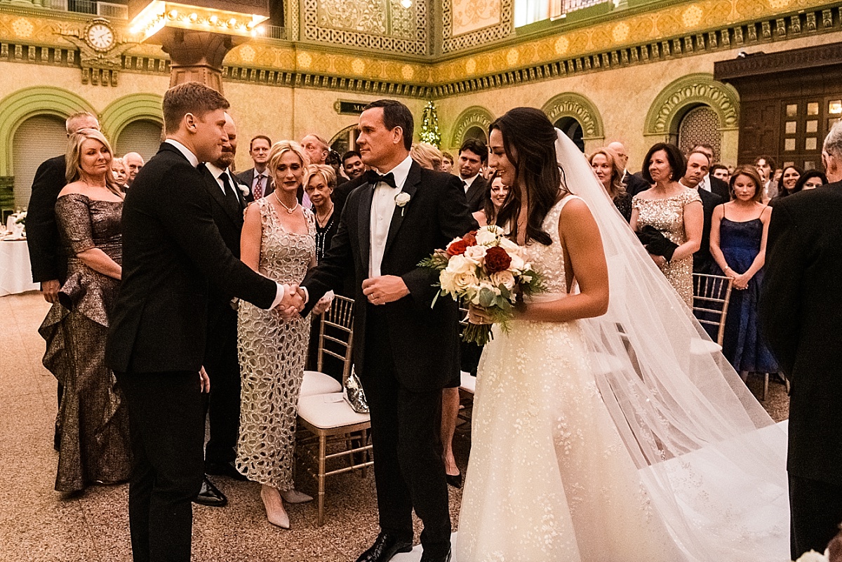 father handing off bride to groom in beautiful St. Louis Union Station wedding photo