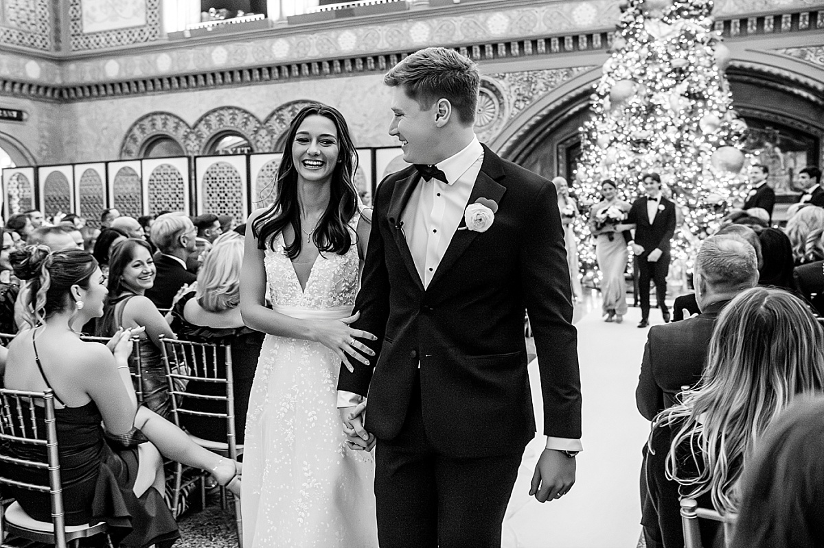 bride and groom walking back down aisle in beautiful St. Louis Union Station wedding photo