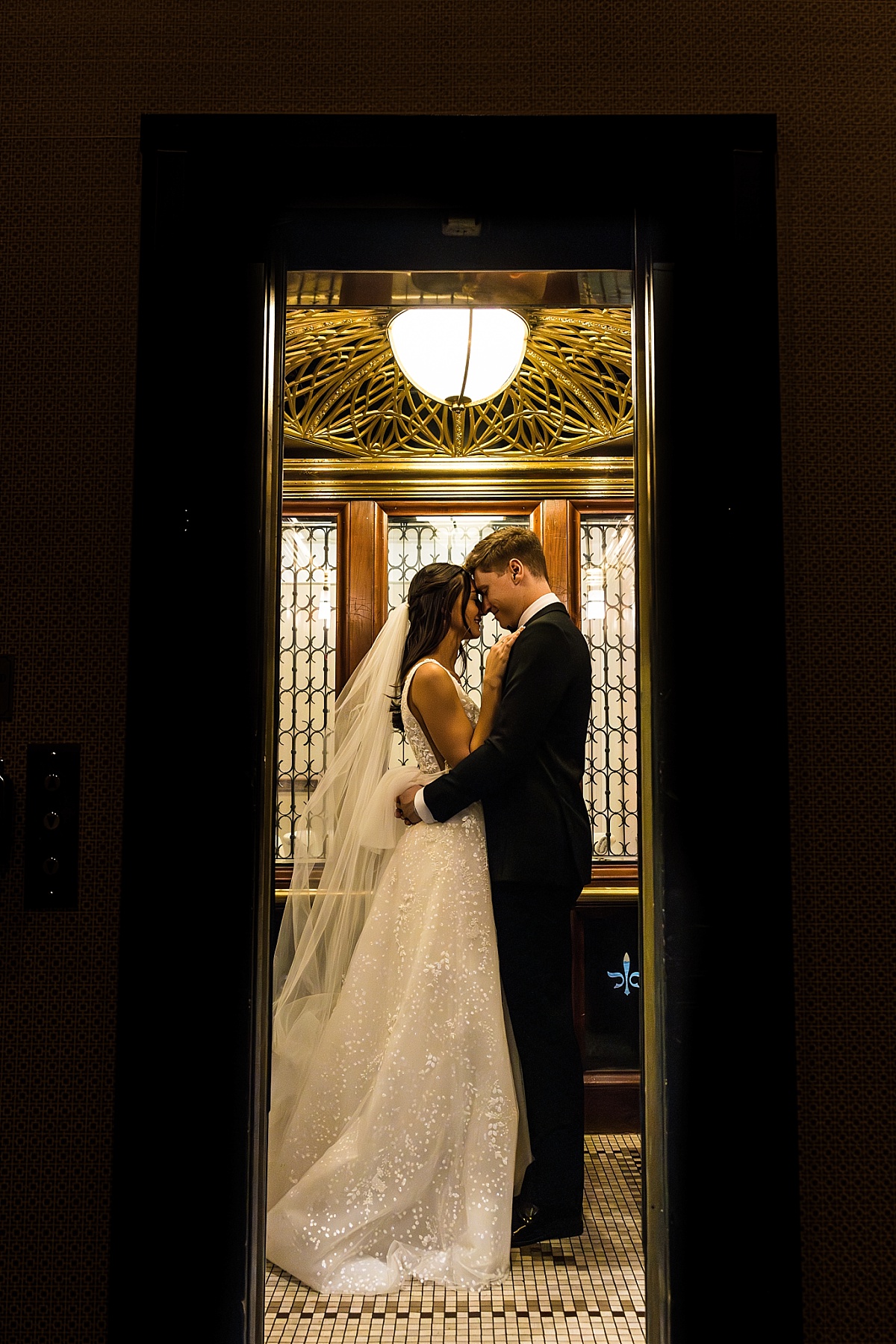 bride and groom in elevator in beautiful St. Louis Union Station wedding photo