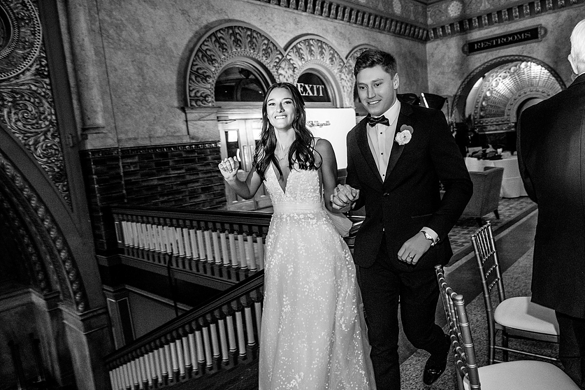 Bride and groom entering reception in fun St. Louis Union Station wedding photo