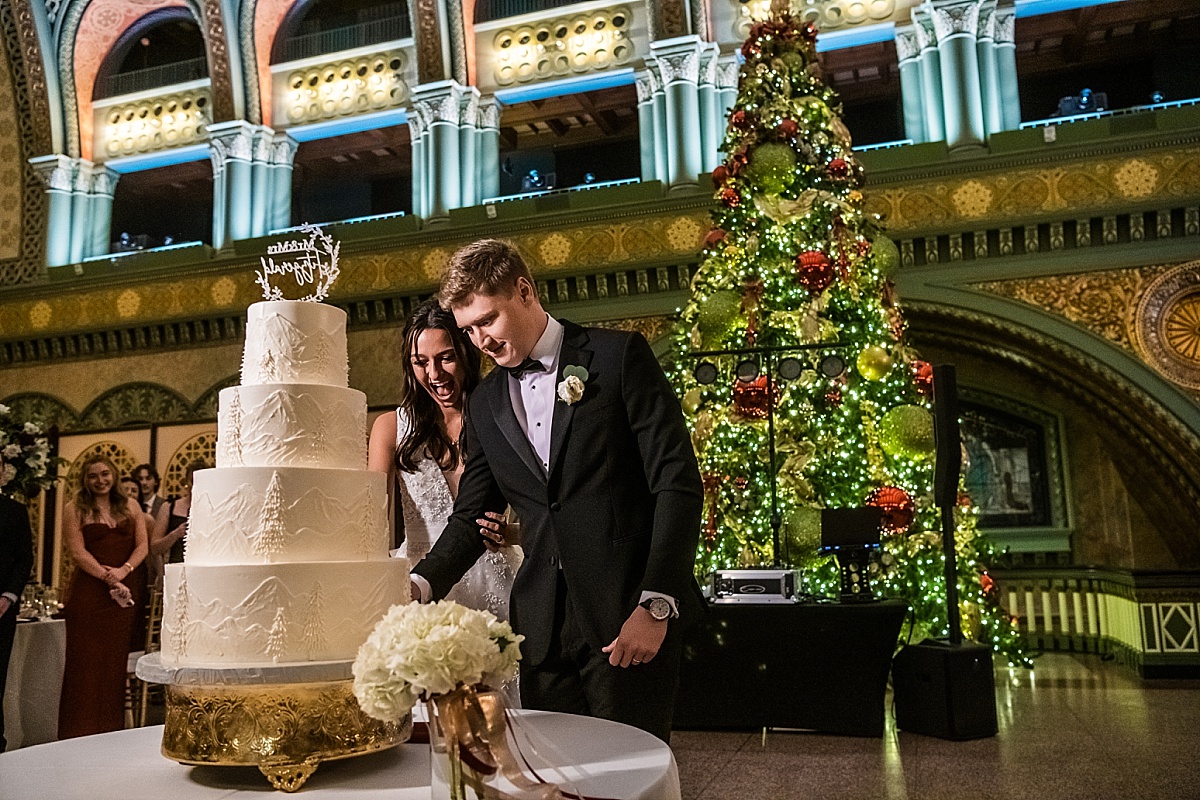 bride and groom cutting the cake in beautiful St. Louis Union Station wedding photo